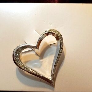 Silver colored heart shape pin with tiny sparkly accents